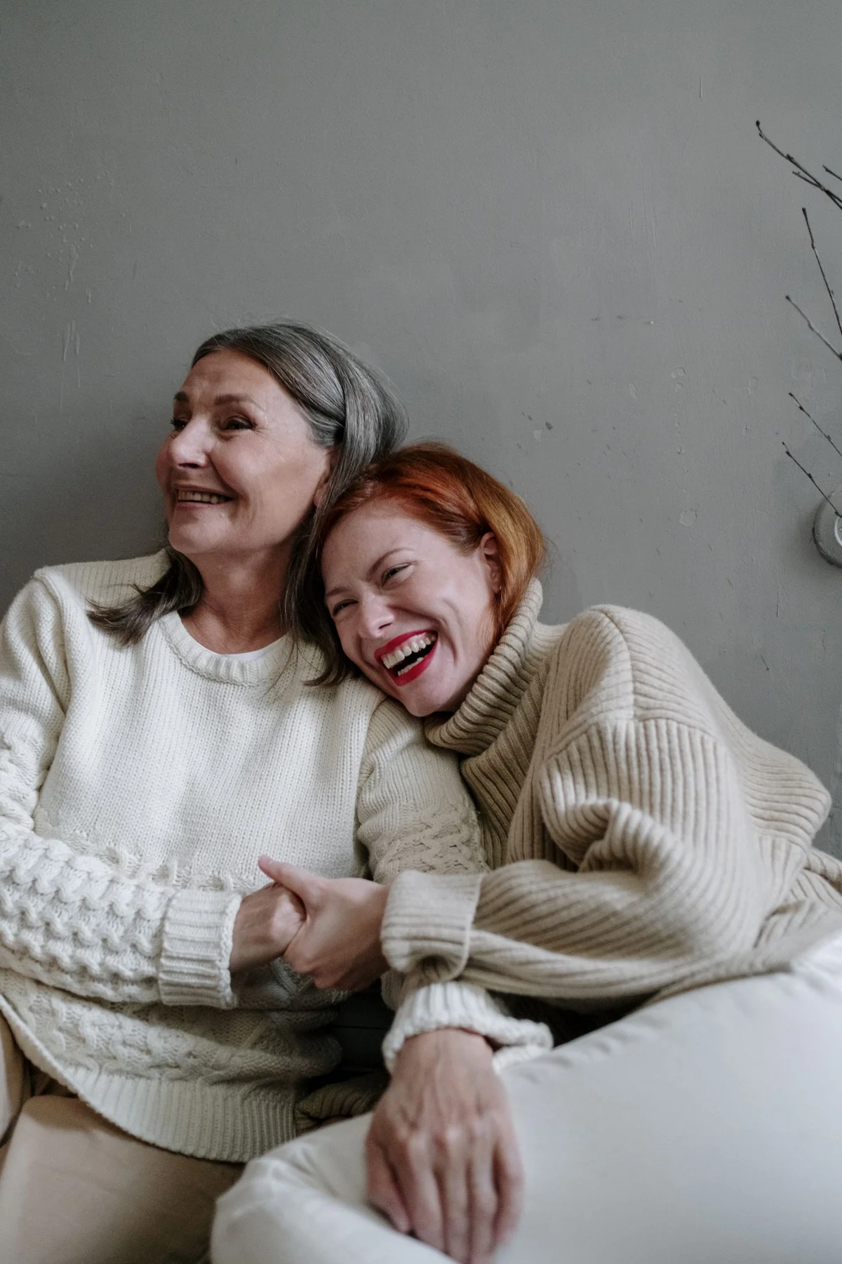 A mother and adult daughter enjoying a warm moment together